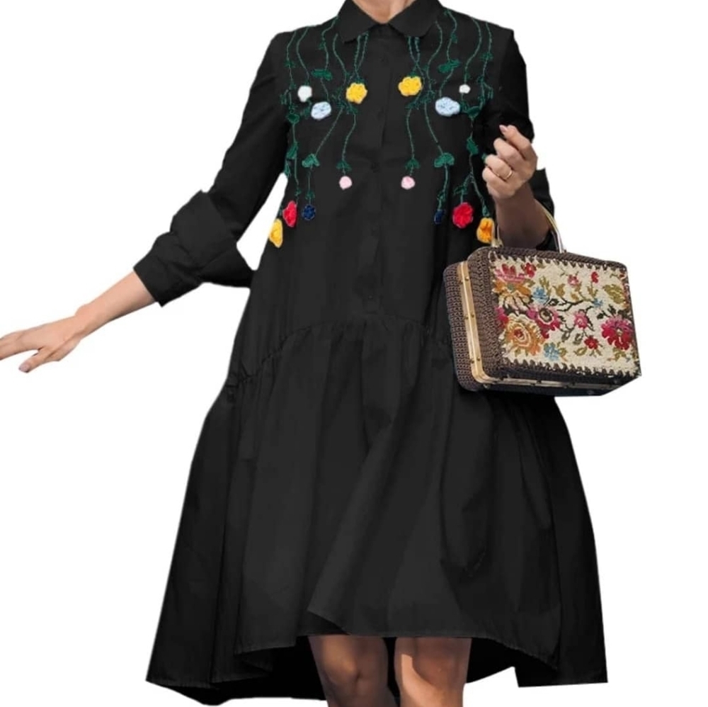 A black, shirt dress with embroidered multi-colored flowers.